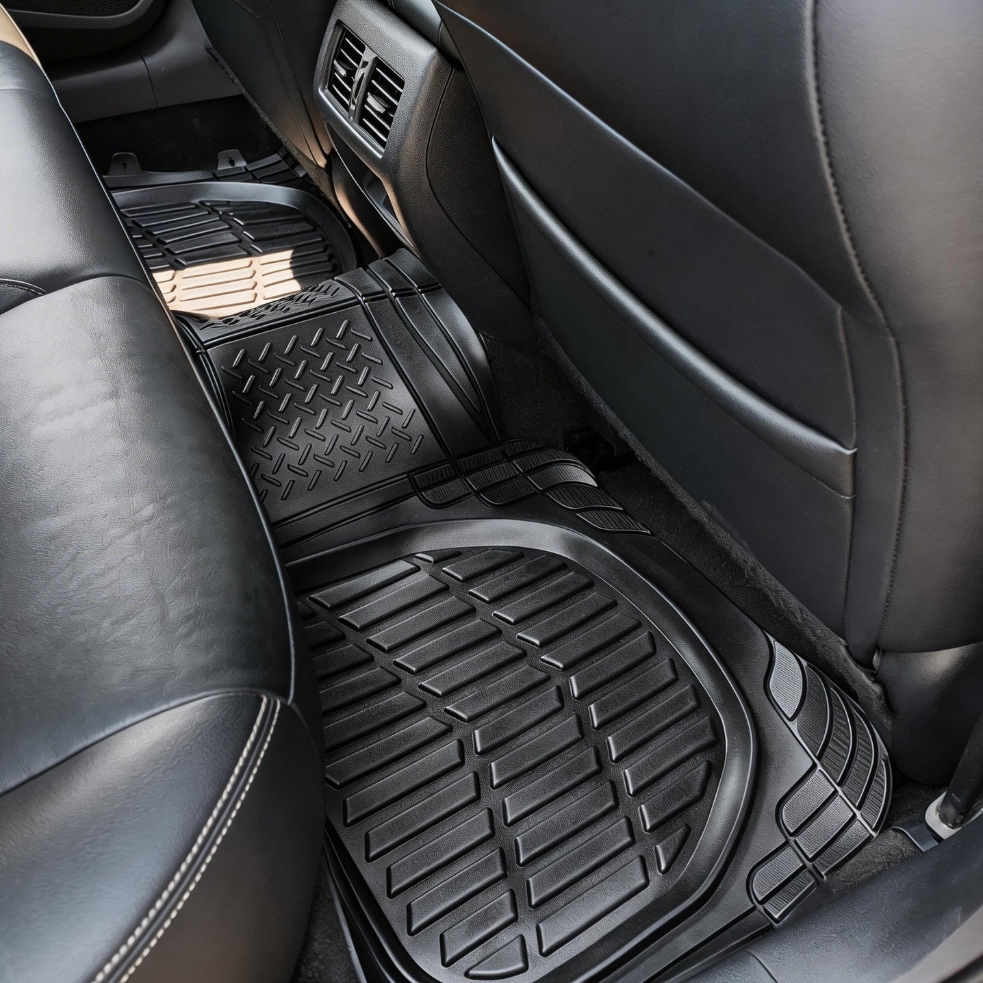 Universal car mats installed in a vehicle interior, showing full coverage and fit for front and rear seats